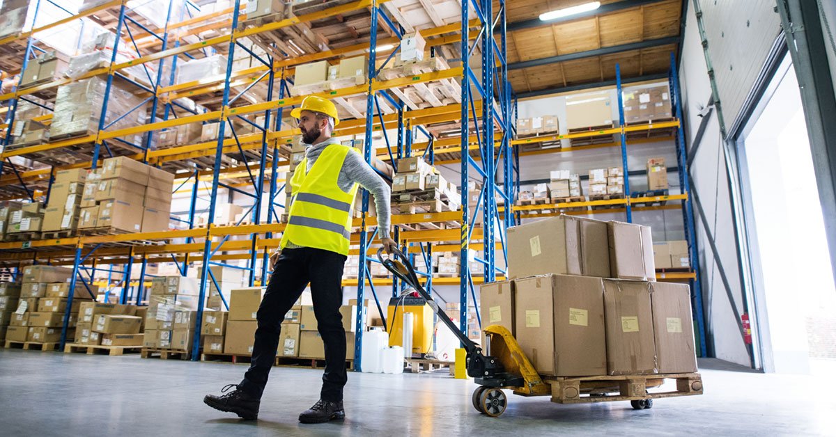 man in awarehouse pulling boxes
